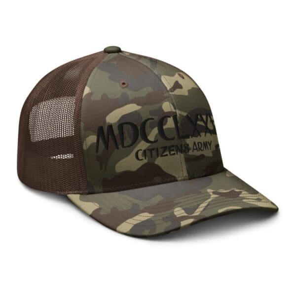 A Camouflage 1247 Snap Back Trucker Hat w/MDCCLXXVI (Black Font) with the word mdcc on it.