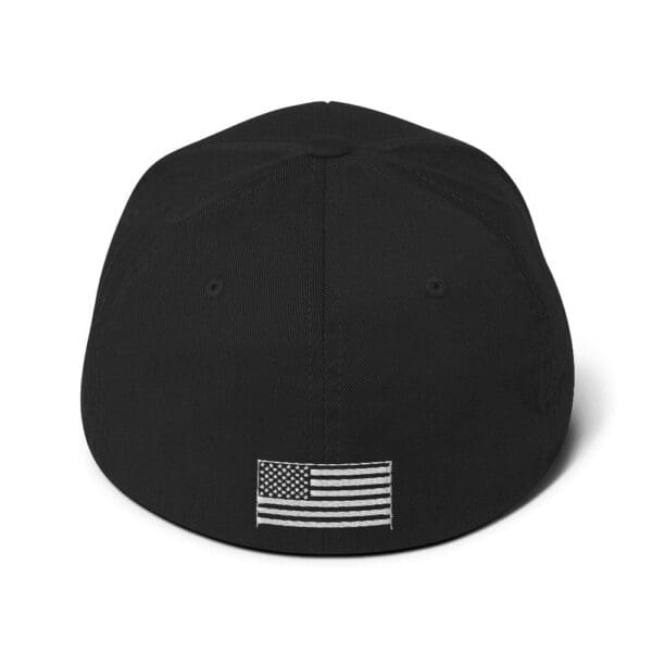 A black 6277 Flexfit Cap w/ White Logo with an american flag on it.