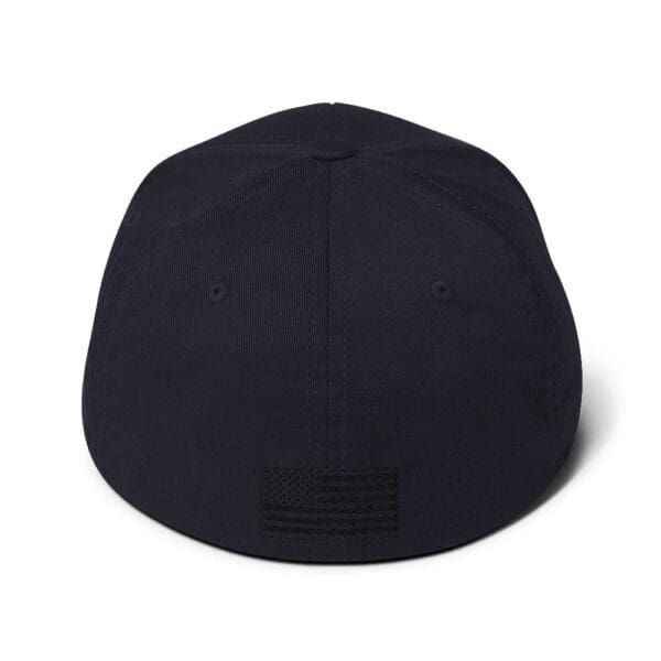 A black 6277 Flexfit Cap w/ Black Logo with an american flag on the back.