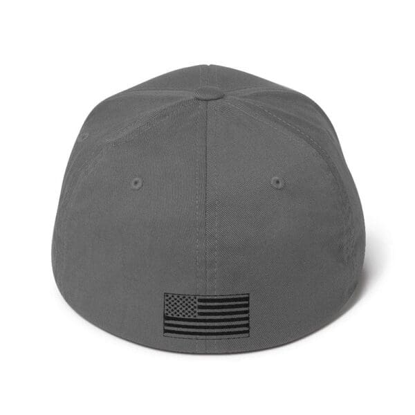 A gray 6277 Flexfit Cap w/ Black Logo with an american flag on it.