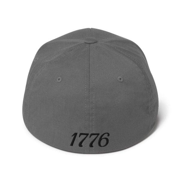 A gray 6277 Flexfit Cap Citizens Army w/ Flag (Black Font) with the word 1776 on it.