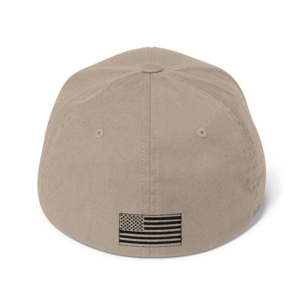 A 6277 Flexfit Cap w/ Black Logo with an american flag on it.