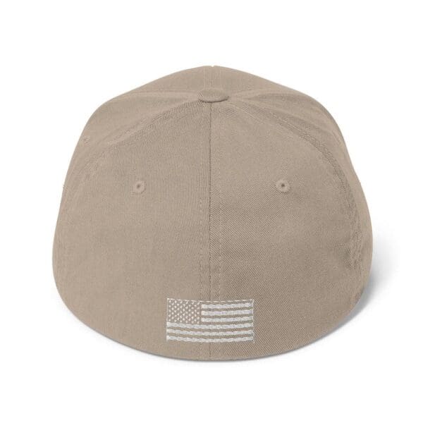 A 6277 Flexfit Cap w/ White Logo with an american flag on it.