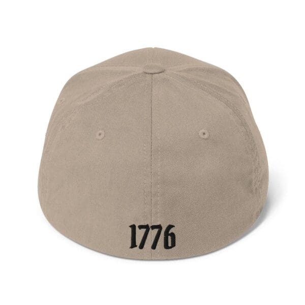 A beige 6277 Flexfit Cap w/Citizens Army (Black Font) with the word 1776 on it.