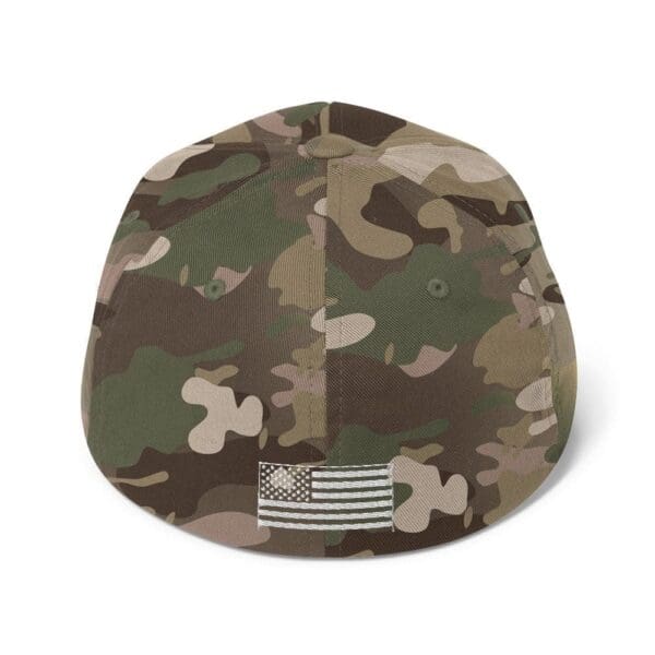 A 6277 Flexfit Cap w/ White Logo with an american flag on it.