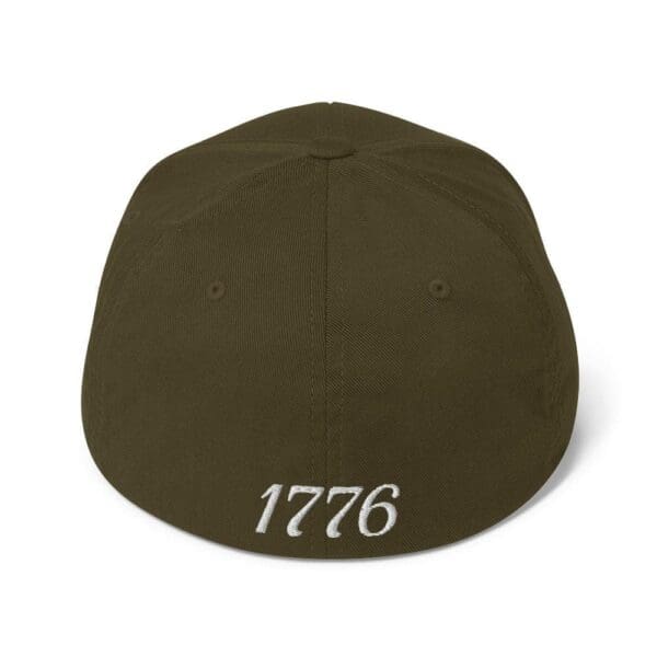 A brown 6277 Flexfit Cap Citizens Army w/ Flag (White Font) with the word 1776 on it.