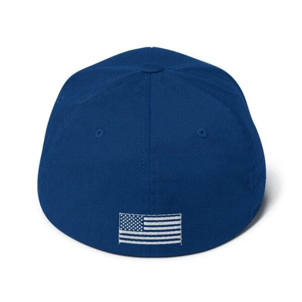 A 6277 Flexfit Cap w/ White Logo with an american flag on it.