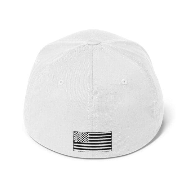 A white 6277 Flexfit Cap w/ Black Logo with an American flag on it.