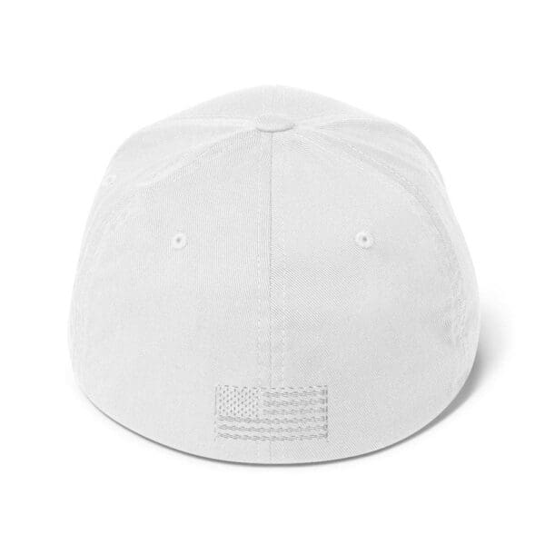 The back of a 6277 Flexfit Cap w/ White Logo with an american flag on it.