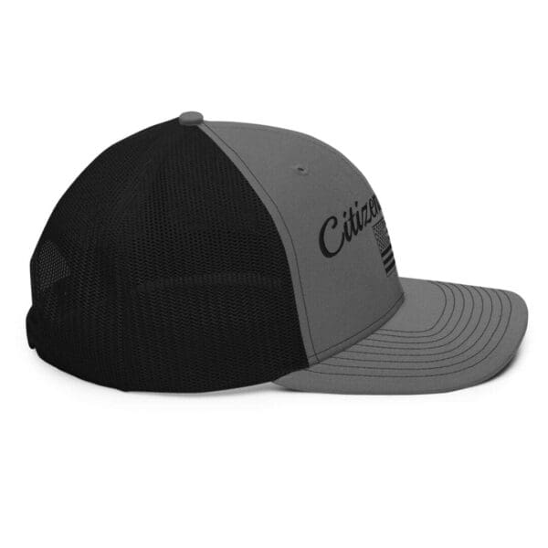 A gray and black 112 Snap Back Trucker Cap Citizens Army w/ Flag (Black Font) hat with the word citizen on it.